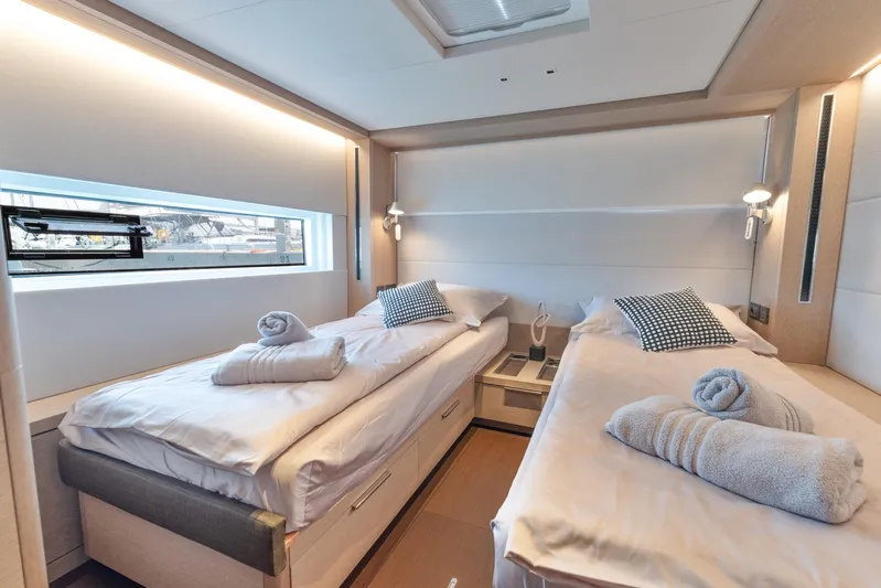  Yacht Photos Pics Luxurious twin cabin interior of 2024 Lagoon SIXTY 5 yacht, featuring modern design and cozy bedding.