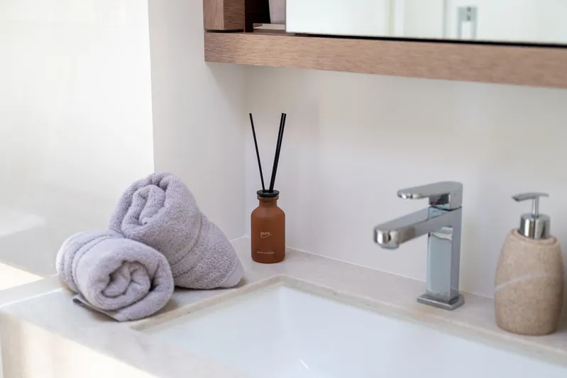  Yacht Photos Pics Luxury bathroom sink with towels and diffuser on Lagoon SIXTY 5 yacht, 2024 model.