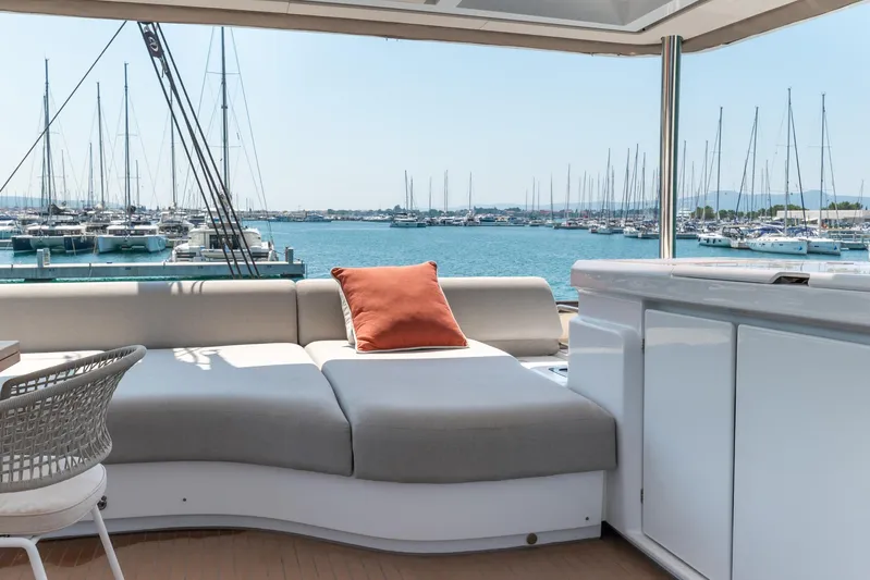 Yacht Photos Pics Luxurious 2024 Lagoon SIXTY 5 yacht interior with marina view and comfortable seating.