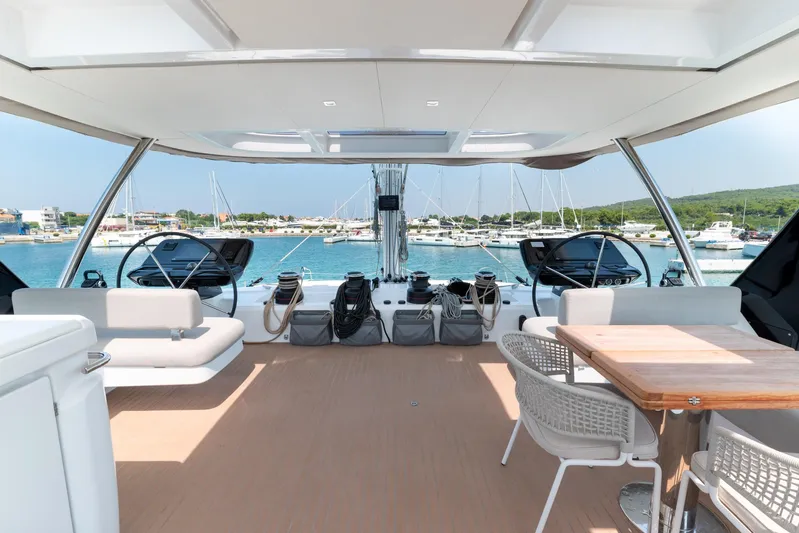  Yacht Photos Pics Luxurious 2024 Lagoon SIXTY 5 yacht interior with ocean view and elegant seating.