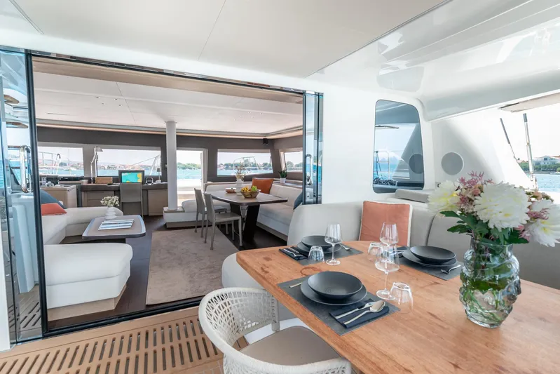  Yacht Photos Pics Luxurious interior of 2024 Lagoon SIXTY 5 yacht with elegant dining and seating areas.