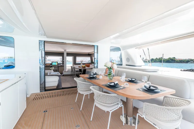  Yacht Photos Pics Luxurious 2024 Lagoon SIXTY 5 yacht interior with elegant dining area and ocean view.