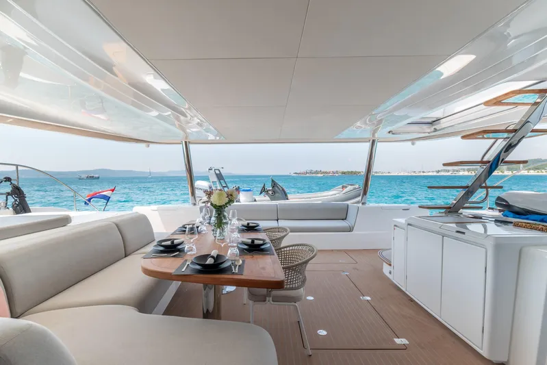  Yacht Photos Pics Luxurious 2024 Lagoon SIXTY 5 yacht interior with elegant dining area and stunning ocean view.