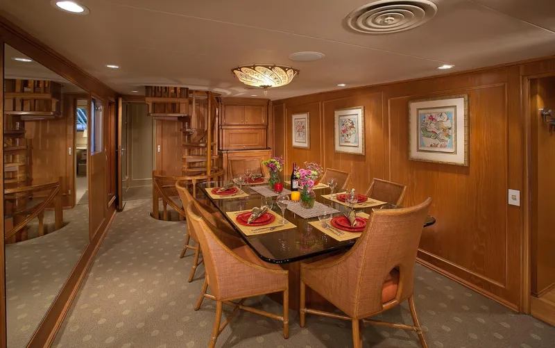 Montego Yacht Photos Pics Luxurious dining area on the 1967 Superyacht Punat with elegant wooden decor.