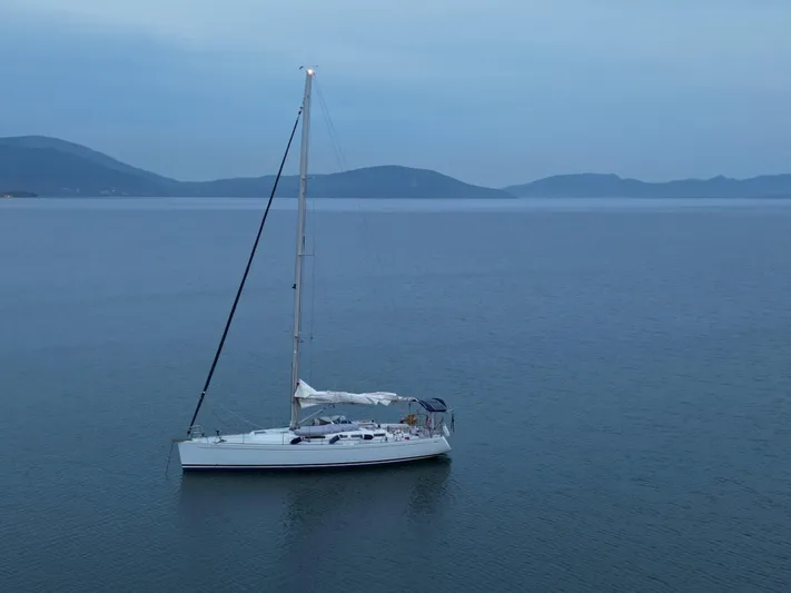 Princess Yacht Photos Pics Sailboat Grand Soleil 45 (2008) on calm waters with distant hills.