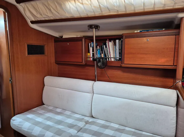 Princess Yacht Photos Pics Interior of 2008 Grand Soleil 45 yacht with wooden cabinets and cushioned seating.