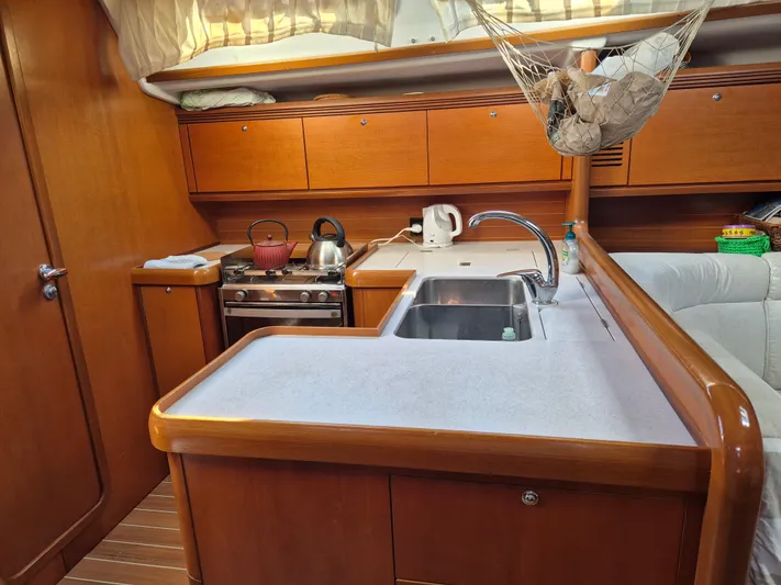 Princess Yacht Photos Pics Grand Soleil 45 yacht kitchen interior, featuring wooden cabinetry and modern appliances, 2008 model.