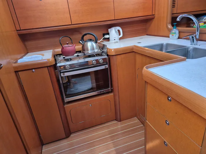 Princess Yacht Photos Pics Grand Soleil 45 yacht kitchen, 2008 model, featuring wooden cabinetry and modern appliances.