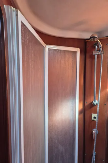 Princess Yacht Photos Pics Shower area inside a 2008 Grand Soleil 45 yacht with wooden paneling.