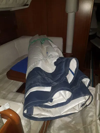 Princess Yacht Photos Pics Rolled sail inside a 2008 Grand Soleil 45 yacht cabin, featuring wooden interior and seating.