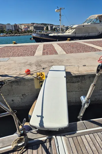 Princess Yacht Photos Pics Gangway of a 2008 Grand Soleil 45 yacht docked at a sunny marina.