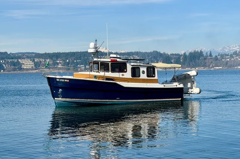  Yacht Photos Pics 2012 Ranger Tugs R-29 boat on calm water with scenic mountain backdrop.