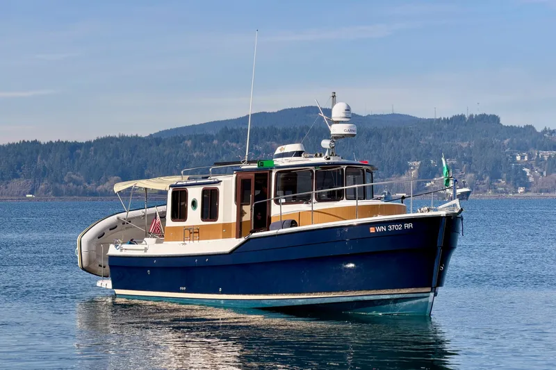  Yacht Photos Pics 2012 Ranger Tugs R-29 boat on calm water with scenic mountain backdrop.