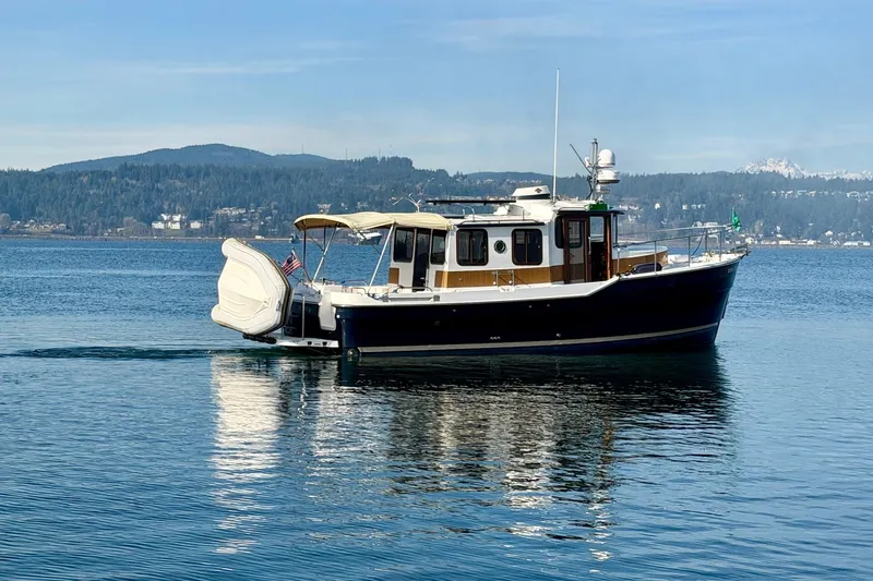  Yacht Photos Pics 2012 Ranger Tugs R-29 boat on calm water with scenic mountain backdrop.