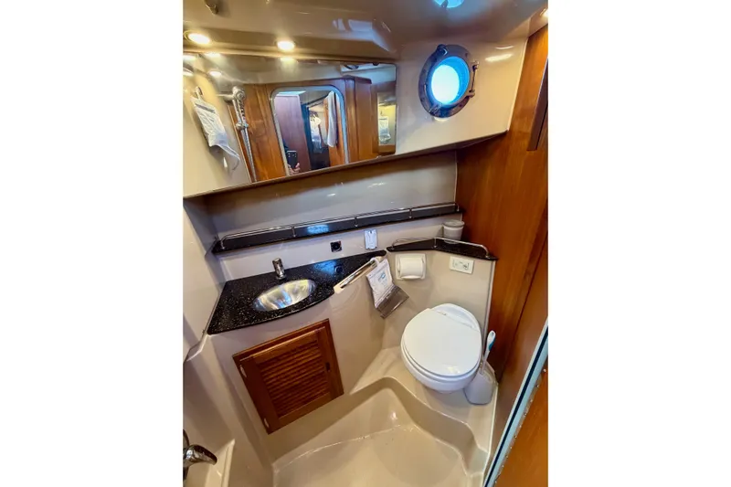 Yacht Photos Pics 2012 Ranger Tugs R-29 boat bathroom with sink, toilet, and porthole window.