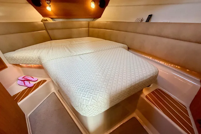  Yacht Photos Pics Cozy cabin interior of 2012 Ranger Tugs R-29 with comfortable bedding and ambient lighting.