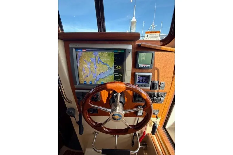 Yacht Photos Pics 2012 Ranger Tugs R-29 helm with navigation display and wooden steering wheel.