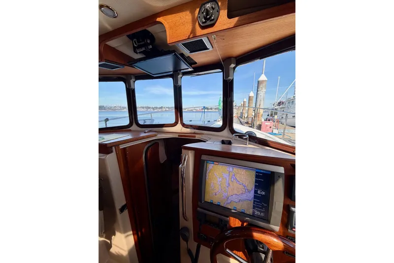  Yacht Photos Pics Interior view of 2012 Ranger Tugs R-29 boat with navigation system and scenic harbor.