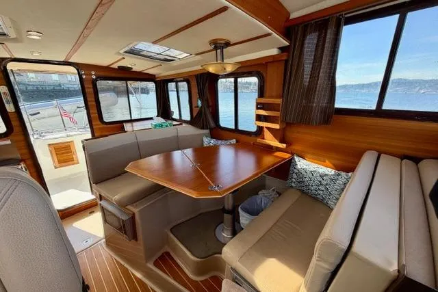  Yacht Photos Pics Interior of 2012 Ranger Tugs R-29 boat with wooden dining area and large windows.