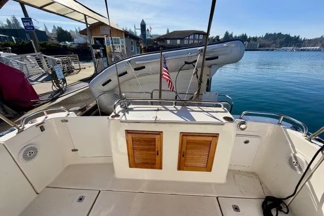  Yacht Photos Pics 2012 Ranger Tugs R-29 boat deck with wooden storage, docked at a marina.