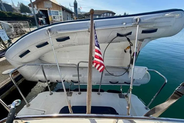  Yacht Photos Pics 2012 Ranger Tugs R-29 with dinghy and American flag at marina dock.