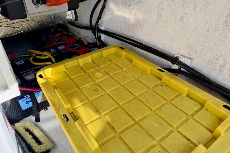  Yacht Photos Pics Yellow storage compartment in 2012 Ranger Tugs R-29 boat, with visible wiring and battery.