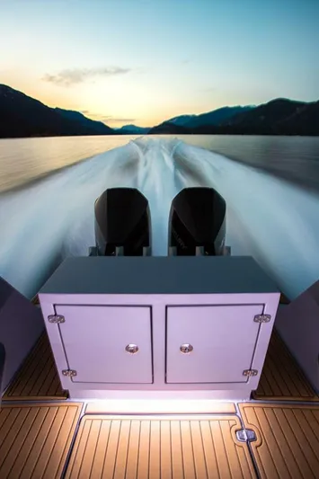  Yacht Photos Pics 2019 Jasper Marine Freedom 28 boat cruising on a serene lake at sunset.