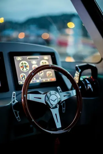  Yacht Photos Pics Steering wheel and dashboard of 2019 Jasper Marine Freedom 28 boat, featuring modern controls.