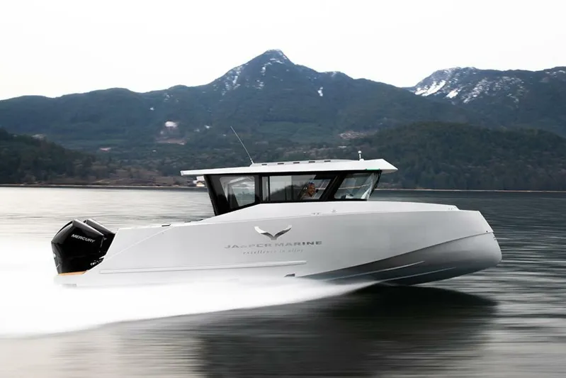  Yacht Photos Pics 2019 Jasper Marine Freedom 28 boat cruising on a serene lake with mountain backdrop.