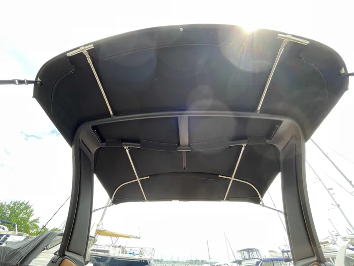  Yacht Photos Pics 2023 Chaparral 287 SSX boat canopy, marina background, sunny day.