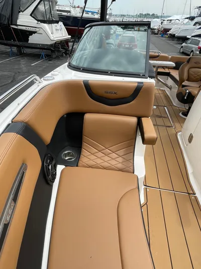  Yacht Photos Pics 2023 Chaparral 287 SSX boat with luxurious tan seating and sleek design.