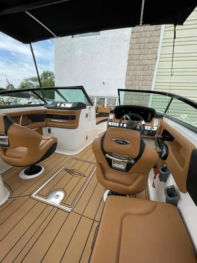  Yacht Photos Pics 2023 Chaparral 287 SSX boat interior with tan seating and modern dashboard.