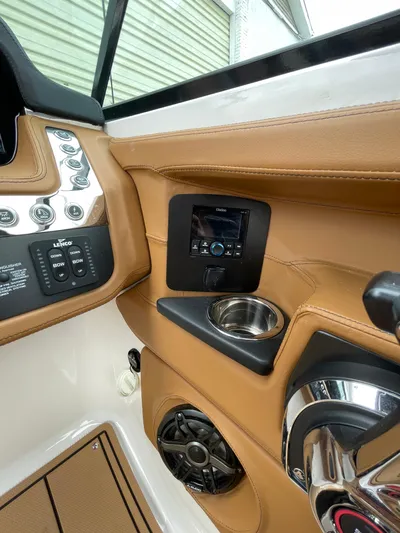  Yacht Photos Pics 2023 Chaparral 287 SSX boat interior with control panel and cup holder.