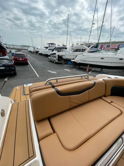  Yacht Photos Pics 2023 Chaparral 287 SSX boat with tan seating at a marina.