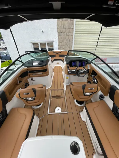  Yacht Photos Pics 2023 Chaparral 287 SSX boat interior with tan seating and modern dashboard.