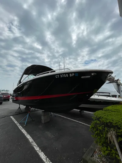  Yacht Photos Pics 2023 Chaparral 287 SSX boat on display under cloudy sky.