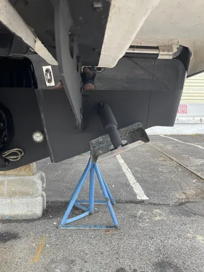  Yacht Photos Pics 2023 Chaparral 287 SSX boat on a stand, showing the hull and propeller area.