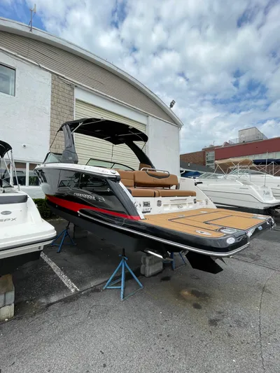  Yacht Photos Pics 2023 Chaparral 287 SSX boat displayed outdoors with sleek design and spacious deck.