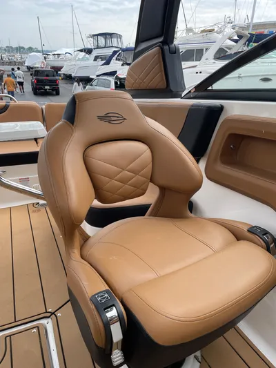  Yacht Photos Pics 2023 Chaparral 287 SSX boat with luxurious tan leather seating at a marina.