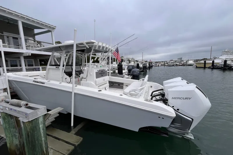  Yacht Photos Pics 2025 Fountain 34 CC boat docked with twin Mercury engines in a marina.