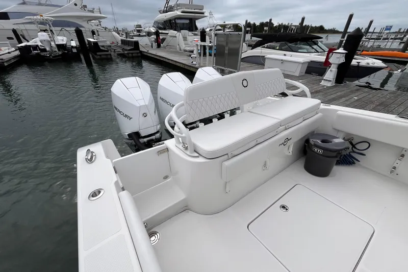  Yacht Photos Pics 2025 Fountain 34 CC boat docked, featuring twin Mercury engines and spacious seating.