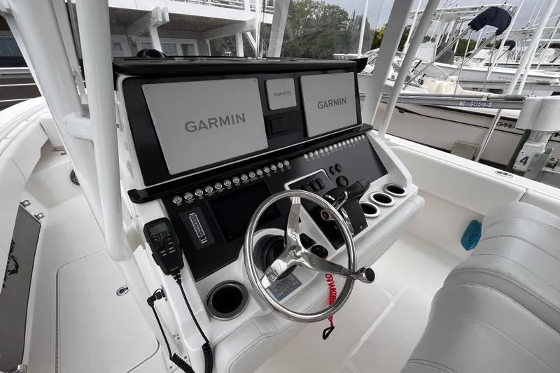  Yacht Photos Pics 2025 Fountain 34 CC boat cockpit with Garmin navigation system and steering wheel.