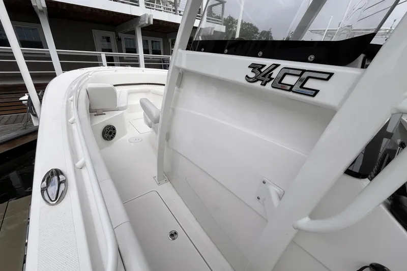  Yacht Photos Pics 2025 Fountain 34 CC boat interior, showcasing sleek white design and seating area.