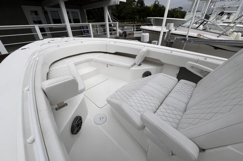  Yacht Photos Pics Luxurious interior of 2025 Fountain 34 CC boat with white quilted seating.