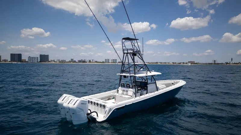 Pharma-sea Yacht Photos Pics 2023 Contender 44 CB boat on open water under a partly cloudy sky.