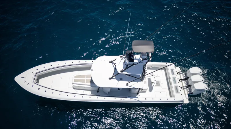 Pharma-sea Yacht Photos Pics 2023 Contender 44 CB boat on open water, aerial view, featuring triple outboard engines.