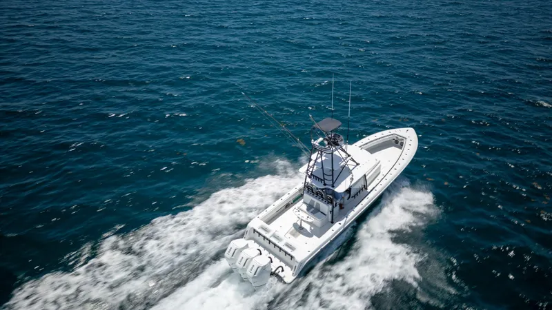 Pharma-sea Yacht Photos Pics 2023 Contender 44 CB boat cruising on open ocean waters.