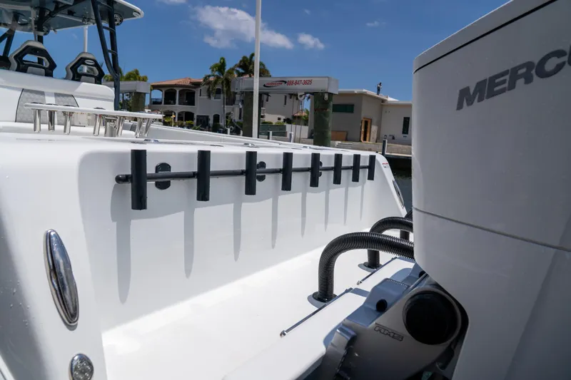 Pharma-sea Yacht Photos Pics 2023 Contender 44 CB boat with Mercury engine, docked under a clear blue sky.
