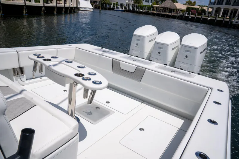 Pharma-sea Yacht Photos Pics 2023 Contender 44 CB boat with triple outboard engines on a calm waterway.