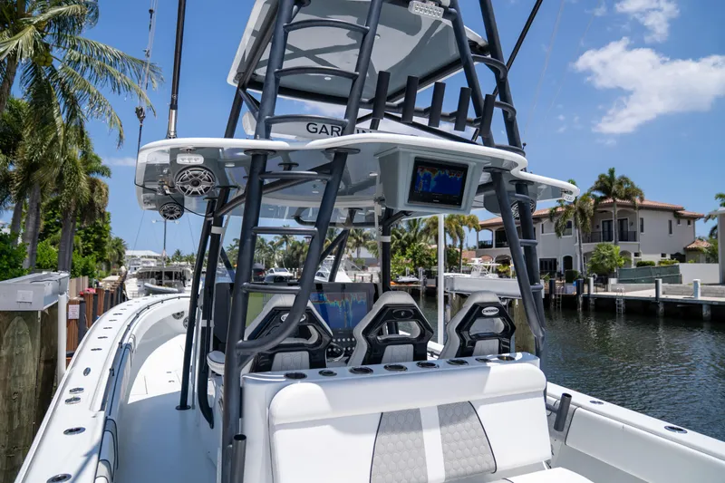 Pharma-sea Yacht Photos Pics 2023 Contender 44 CB boat with advanced navigation system, docked by a canal under a clear sky.